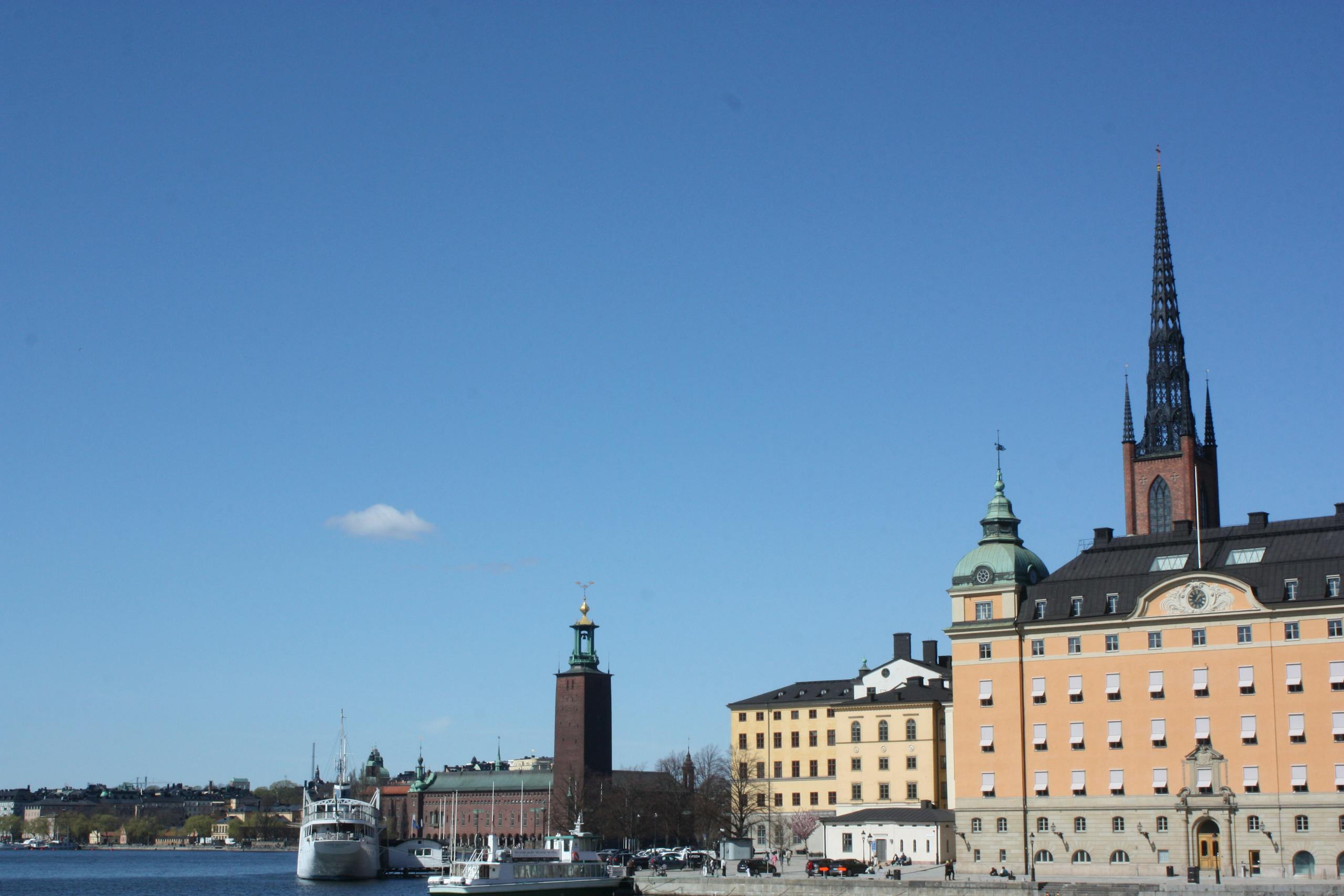 Iconic view of Riddarholmen waterfront with historical buildings and City Hall in Stockholm, Sweden.